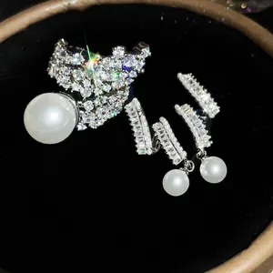 Detailed macro view of sparkling zircon and pearl ring and earring jewelry set