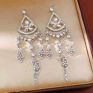 Close-up of elegant silver needle floral tassel earrings encrusted with sparkling rhinestones