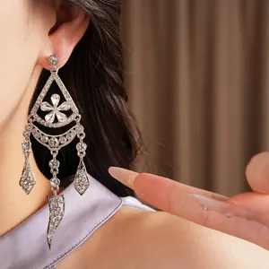 Detail close-up of silver rhinestone flower tassel earrings with refined European style