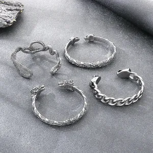 Set de 4 brazaletes punk de acero vintage con diseños de cabezas de león y serpiente