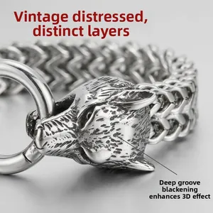Detailed macro shot of vintage dual wolf head bracelet with dark oxidation finish
