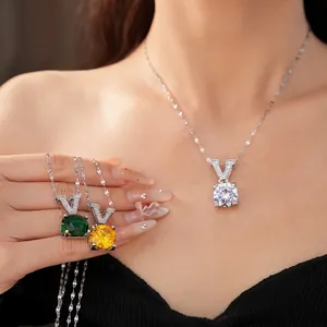 Elegant V-shaped zircon pendant necklace set in white, green, and yellow sparkling gemstones.