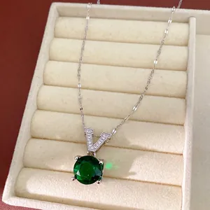 Elegant silver chain necklace featuring a large green round zircon and V-shaped bail