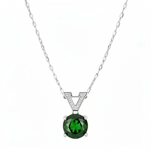Elegant silver necklace with V-shaped zircon pendant and a round green gemstone.