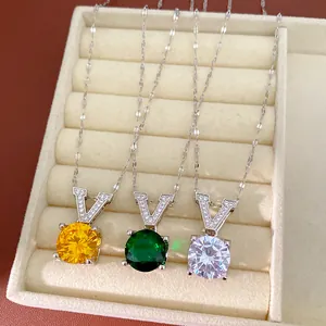 Detail view of minimalist zircon V-shaped necklaces with round gemstones in three colors