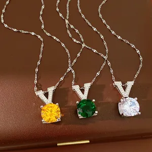 Close-up of elegant V-shaped necklaces with sparkling round cubic zirconia in three colors