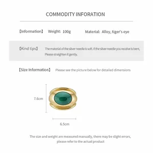Detailed specification view of a gold-tone oval twisted bangle with tiger eye stone