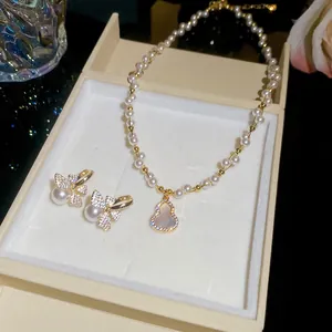 French vintage pearl necklace and bowknot earrings set presented in an elegant jewelry box