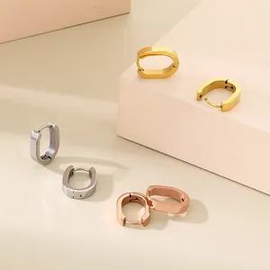 Minimalist stainless steel oval hoop earrings in gold, silver, and rose gold finishes.