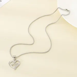 Detail of stainless steel heart necklace with Mom lettering and sparkling crystals