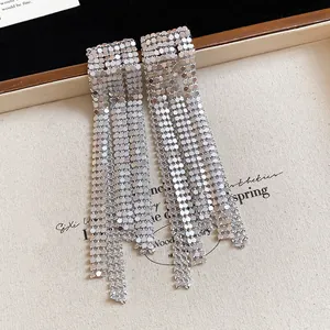 High-definition close-up showing the intricate metallic mesh and long tassel detail of these silver earrings