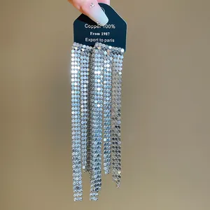Detailed view of long silver metallic fringe tassel earrings for evening parties