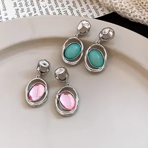 French vintage silver-tone earrings with teal and pink oval acrylic pendants details.