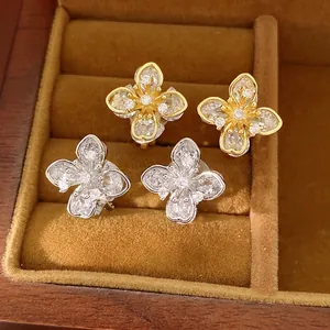 Elegant four-leaf clover zirconia flower ear clips in gold and silver finish