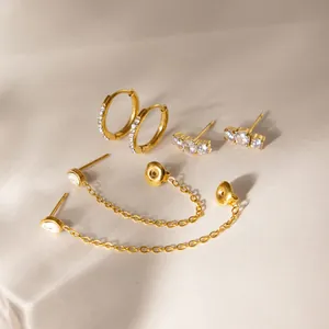 Macro view of gold-plated stainless steel earring set with sparkling cubic zirconia.