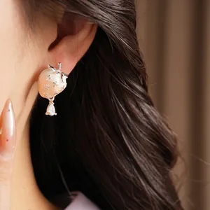Elegant silver needle strawberry stud earrings with zircon drop pendant on model ear