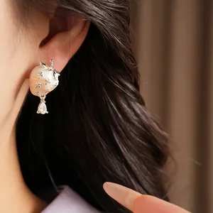 Detailed close-up of a sweet strawberry stud earring with a sparkling zirconia drop.
