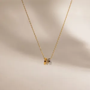 Macro detail view of 18k gold-plated stainless steel triple interlocking ring necklace