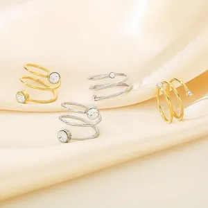 Detailed view of minimalist spiral stainless steel rings with clear zirconia stones