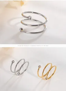 Detail shot of gold and silver stainless steel spiral rings with sparkling zircon accents.