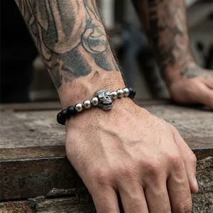 Detail of vintage skull bracelet with black onyx beads and sparkling inlaid crystal eyes
