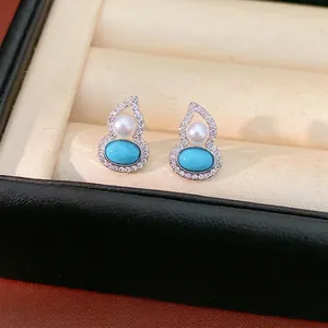 Elegant gourd-shaped silver earrings with pearls and turquoise stones in a luxury box