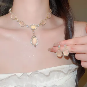 Gros plan d'un élégant ensemble collier et boucles d'oreilles en pierre œil de chat