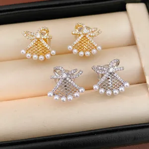 Close-up of bowknot fan-shaped pearl clip earrings in gold and silver finish