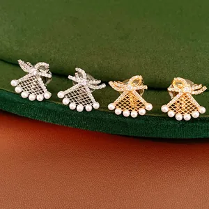 Close-up of bowknot and fan-shaped pearl earrings with gold plating and rhinestones
