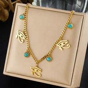Close-up detail of Eye of Horus and turquoise pendants on a gold stainless steel chain