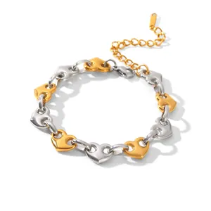 Close-up of two-tone stainless steel heart-shaped link bracelet in gold and silver