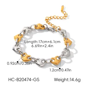 Macro detail of a two-tone stainless steel heart bracelet with size measurements