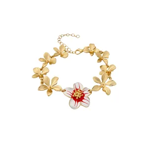 Enamel flower bracelet with gold petals and a red white floral centerpiece