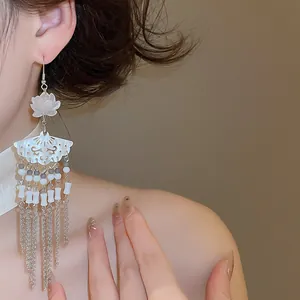 Elegant close-up of New Chinese style fan-shaped flower tassel earrings on ear lobe