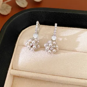 Elegant cluster earrings with white pearls and sparkling cubic zirconia stones in silver