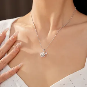 Detailed close-up of elegant flower cluster pearl necklace worn on a model's graceful neckline