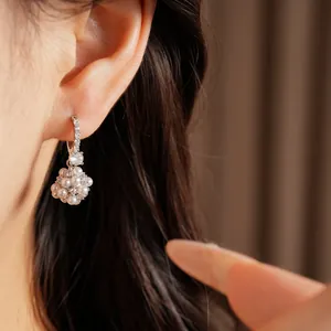 Close-up of elegant pearl cluster flower ball earrings with cubic zirconia accents