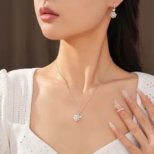 Detail view of an elegant zircon flower cluster pearl necklace and earring jewelry set