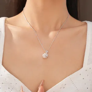 Detailed close-up showing an elegant floral cluster pendant necklace with pearls and zircons