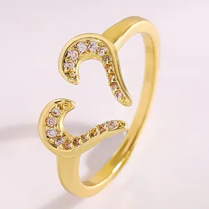Close-up of gold-plated open ring featuring sparkling heart-shaped zircon inlay