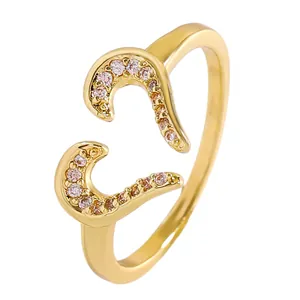 Detail view of a gold-plated adjustable ring featuring twin heart shapes with zircons.