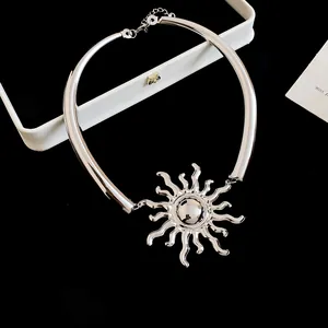 Collana girocollo con ciondolo a sole in argento lucido, dettaglio su nero