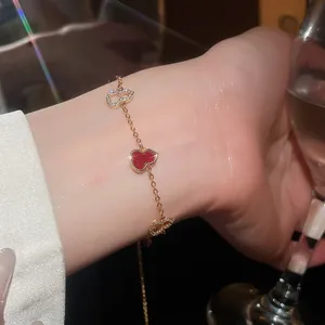 Close-up of 18k gold plated gourd bracelet with sparkling zircons on a woman's wrist.