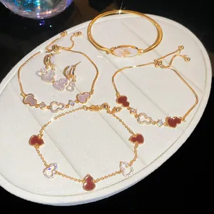 Macro detail of 18k gold plated jewelry set featuring sparkling zircon gourd charms