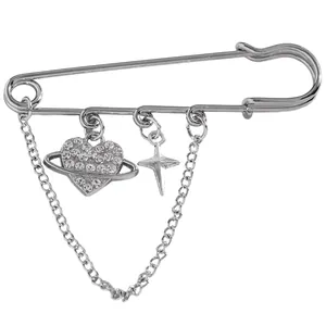 Detail shot of silver safety pin brooch with rhinestone heart planet and star charms