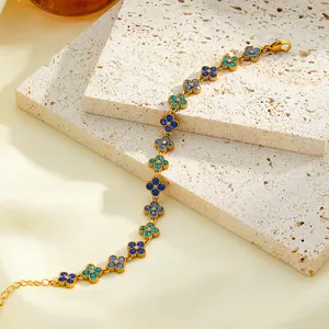 Detail showing luxury gold stainless steel bracelet with blue crystal flowers