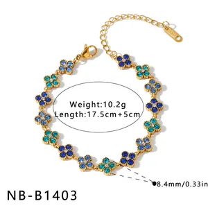 Detailed view of elegant gold-plated floral bracelet featuring sparkling blue rhinestones