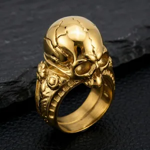 Macro view of a gold gothic skull ring highlighting the intricate cracked skull details