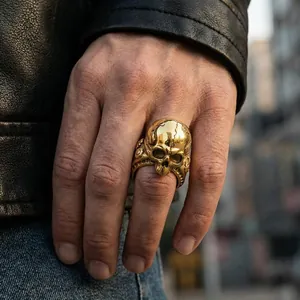 Close-up detail of a vintage gold cracked skull ring for men in a gothic dark style