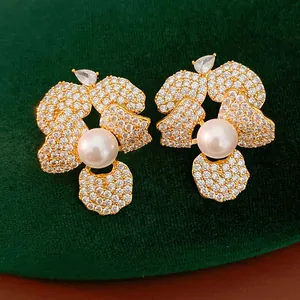 Detailed macro view of S925 silver needle flower earrings with pearl and cubic zirconia